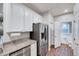 Bright kitchen featuring granite countertops, stainless steel appliances, and white cabinetry at 518 Judge Ct, Durham, NC 27703