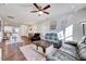 Bright living room with ceiling fan, modern furniture, and hardwood floors at 518 Judge Ct, Durham, NC 27703