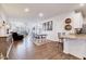 Open living room featuring hardwood floors, comfortable seating, and a bright dining area at 518 Judge Ct, Durham, NC 27703