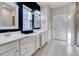 Well-lit bathroom showcasing double sinks, white cabinetry, and a window for natural light at 518 Judge Ct, Durham, NC 27703