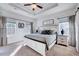 Spacious bedroom featuring tray ceilings, a ceiling fan, and plenty of natural light from large windows at 518 Judge Ct, Durham, NC 27703