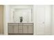 Bathroom featuring a double vanity with neutral cabinetry, a large mirror, and a calming color palette at 533 Morning Light Dr # 33, Angier, NC 27501