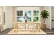 Bright dining room featuring a wooden table set with white chairs and neutral rug at 533 Morning Light Dr # 33, Angier, NC 27501