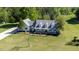 Expansive aerial view of a two-story home with a large lawn and surrounding trees at 530 Turlington Rd, Dunn, NC 28334