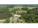 Scenic aerial shot of the property showing surrounding fields, woods, and road access at 530 Turlington Rd, Dunn, NC 28334