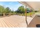 Wide wooden deck with railing and views of the verdant lawn and surrounding trees at 530 Turlington Rd, Dunn, NC 28334