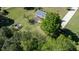 Vast green backyard with a large tree, garden, and a wooden deck attached to the house at 530 Turlington Rd, Dunn, NC 28334
