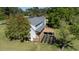 Rear exterior showcasing a multi-level deck, garden area, and a well-manicured lawn with large trees at 530 Turlington Rd, Dunn, NC 28334
