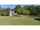 Expansive backyard featuring a garden area, a trampoline, and mature trees at 530 Turlington Rd, Dunn, NC 28334