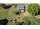 Spacious backyard with a wooden deck, gardening area, lush green lawn, and mature trees at 530 Turlington Rd, Dunn, NC 28334