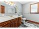 Light and airy bathroom with a wood vanity, gold fixtures, and decorative tile flooring at 530 Turlington Rd, Dunn, NC 28334