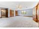 Large bedroom with plush carpet, ceiling fan, an open doorway, and wood trim throughout at 530 Turlington Rd, Dunn, NC 28334