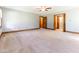 Open bedroom featuring plush carpet, wood trim, and hallway access at 530 Turlington Rd, Dunn, NC 28334