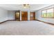 Large bedroom with plush carpet, wooden trim, ceiling fan, and an open doorway to another room at 530 Turlington Rd, Dunn, NC 28334