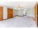 Spacious bedroom with plush carpet, wooden trim and an open doorway to another room at 530 Turlington Rd, Dunn, NC 28334