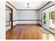 Bright dining room featuring hardwood floors, wood trim, and exterior access to a deck at 530 Turlington Rd, Dunn, NC 28334