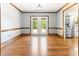 Open dining room featuring hardwood floors, wood trim, and easy access to the kitchen at 530 Turlington Rd, Dunn, NC 28334
