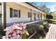 Charming covered front porch with flowering shrubs and brick walkway leading to entrance at 530 Turlington Rd, Dunn, NC 28334
