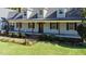 Inviting front porch featuring stately columns and manicured landscaping at 530 Turlington Rd, Dunn, NC 28334