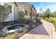 Landscaped front yard with a stone-lined pond, brick pathway, and blossoming azaleas at 530 Turlington Rd, Dunn, NC 28334