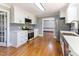 Modern kitchen with white cabinets, stainless steel appliances, and hardwood floors at 530 Turlington Rd, Dunn, NC 28334