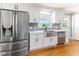 Updated kitchen with stainless steel appliances, farmhouse sink, and modern cabinetry at 530 Turlington Rd, Dunn, NC 28334