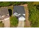 Aerial view of a well-maintained home with a driveway and mature trees at 6 Dawson Ct Ct, Durham, NC 27703