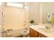 Bathroom with a white tub-shower combination and vanity with wood-look flooring at 6 Dawson Ct Ct, Durham, NC 27703