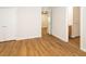 Bedroom features wood-look flooring, neutral paint, and an open doorway to the hallway at 6 Dawson Ct Ct, Durham, NC 27703
