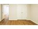 Bedroom features wood-look flooring, neutral paint, and a double closet at 6 Dawson Ct Ct, Durham, NC 27703