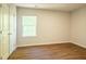 Bright bedroom features wood-look flooring and a large window for natural light at 6 Dawson Ct Ct, Durham, NC 27703
