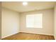 Bedroom features wood-look flooring, a window for natural light, and neutral paint at 6 Dawson Ct Ct, Durham, NC 27703