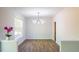 Bright dining room features stylish modern chandelier and wood-look floors at 6 Dawson Ct Ct, Durham, NC 27703