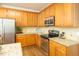 Modern kitchen showcasing wood cabinets, granite countertops, stainless steel appliances, and stylish backsplash at 6 Dawson Ct Ct, Durham, NC 27703