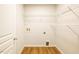 Bright laundry room with wood-look flooring and wire shelving for storage at 6 Dawson Ct Ct, Durham, NC 27703