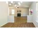 Open-concept living room with a fireplace, wood-look flooring, and ample natural light, creating an inviting space at 6 Dawson Ct Ct, Durham, NC 27703