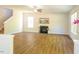 Bright, airy living room with a cozy fireplace, wood-look flooring, and ample natural light at 6 Dawson Ct Ct, Durham, NC 27703