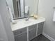 Bright bathroom showcasing a vanity with a white countertop and gray cabinets, and a large mirror at 6022 Four Townes Lane Ln, Raleigh, NC 27616