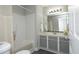 Well-lit bathroom featuring a shower-tub, vanity with gray cabinets, and modern fixtures at 6022 Four Townes Lane Ln, Raleigh, NC 27616