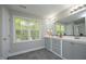 Bathroom featuring a double sink vanity and a bright window view at 6022 Four Townes Lane Ln, Raleigh, NC 27616