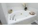 Relaxing soaking tub with marble-style tile surround at 6022 Four Townes Lane Ln, Raleigh, NC 27616