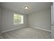 Empty bedroom features neutral colored walls and carpet at 6022 Four Townes Lane Ln, Raleigh, NC 27616