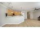 Open layout with a kitchen, breakfast bar, wood floors, and neutral walls for versatile design options at 6022 Four Townes Lane Ln, Raleigh, NC 27616