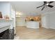 Open-concept living room with hardwood floors, a fireplace, and seamless flow into the kitchen area at 6022 Four Townes Lane Ln, Raleigh, NC 27616