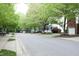Quiet street view lined with mature trees and well-maintained homes and landscaping at 6022 Four Townes Lane Ln, Raleigh, NC 27616