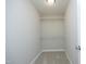 Walk-in closet with shelving and carpet at 6022 Four Townes Lane Ln, Raleigh, NC 27616