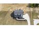 Aerial view of a two-story home with dormers, a long driveway, and manicured yard at 67 Farmstead Ct, Wendell, NC 27591