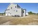 Exterior view of the home and back yard with lawn and HVAC units at 67 Farmstead Ct, Wendell, NC 27591
