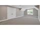 This bedroom features neutral walls, carpet, a window with a view, and closet doors at 67 Farmstead Ct, Wendell, NC 27591
