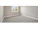 A view of a bedroom with carpet, a window, and neutral paint at 67 Farmstead Ct, Wendell, NC 27591